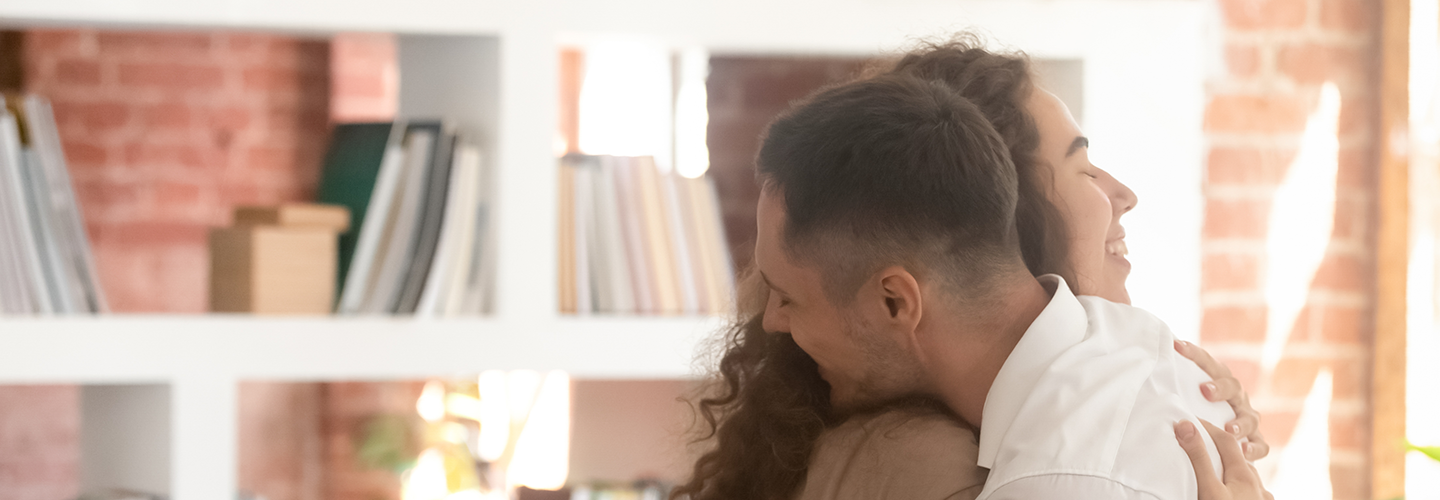 Two adults hugging