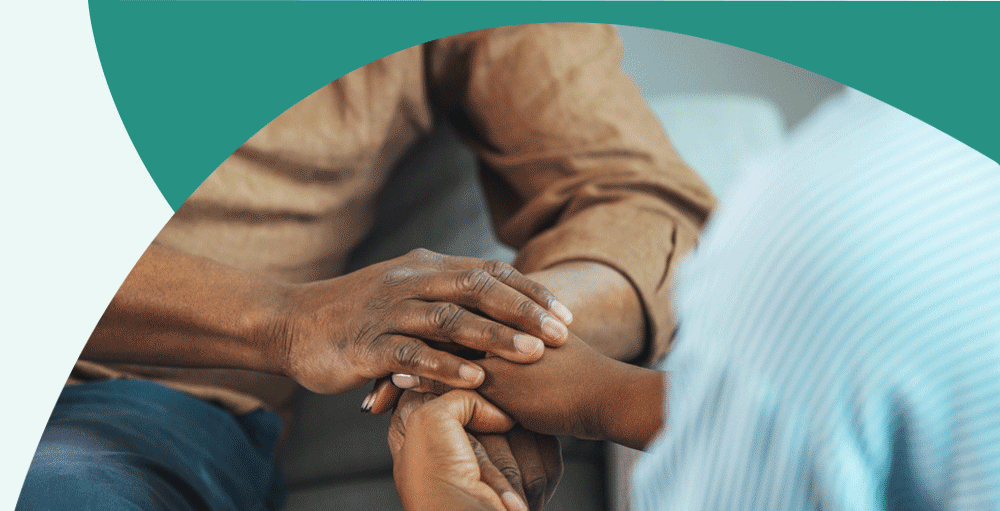 Two people of color holding hands