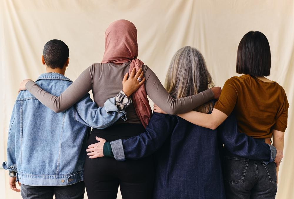 Women hugging and facing away from the camera