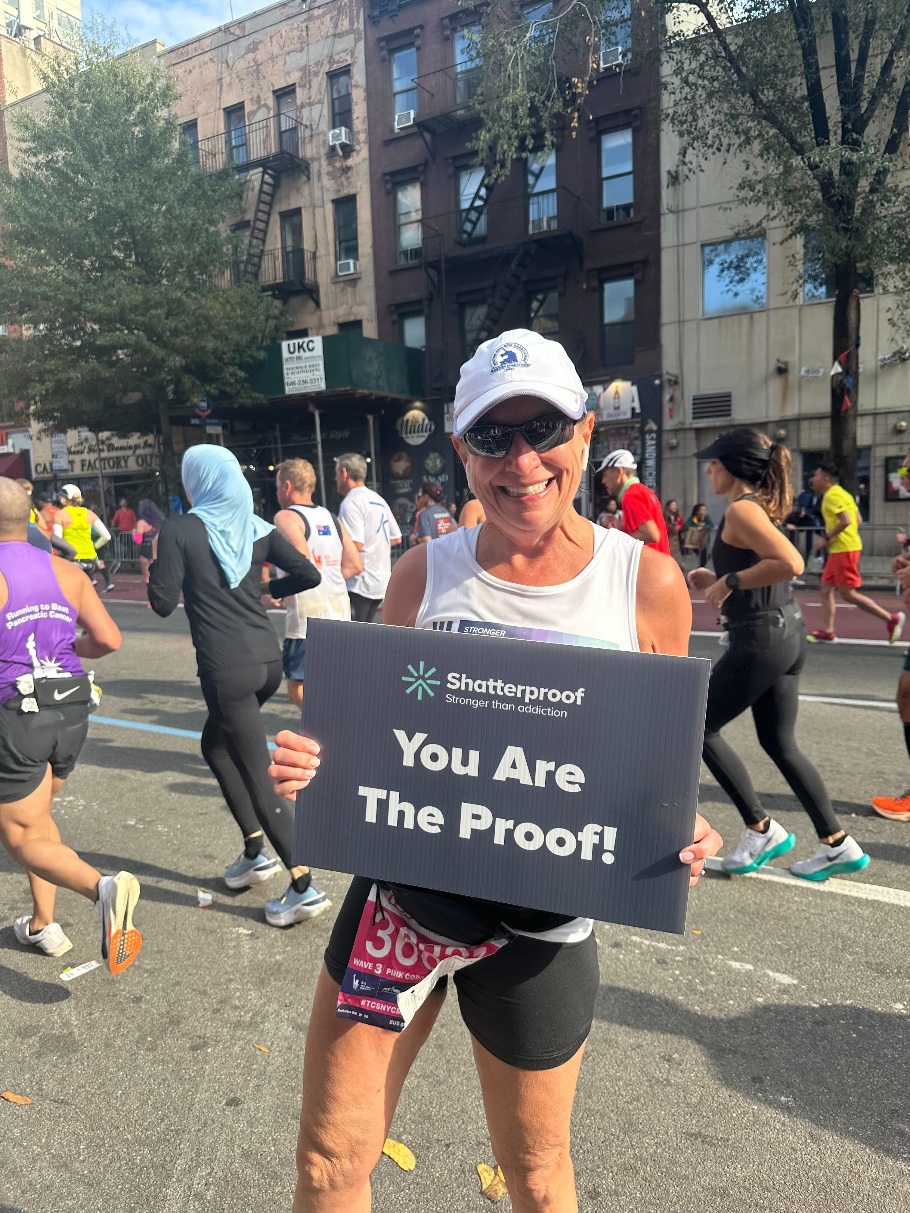 Woman holding up sign at marathon
