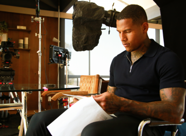 NFL player Darren Waller learning his lines on set