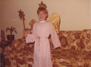 A childhood photo of the author dressed up like an angel
