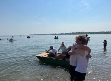 Two people hugging with a lake in the background during the Showdown on the Sound event