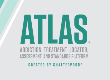 A logo of ATLAS with green text on a grey background