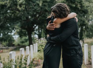 Man and woman hugging and coping with grief 