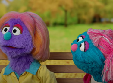 Two muppets talking in a park
