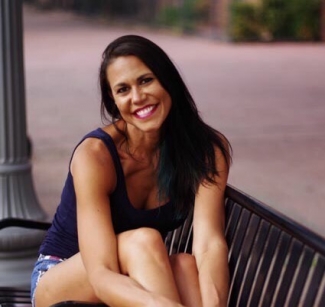 The author, Jen, sitting on a park bench, smiling