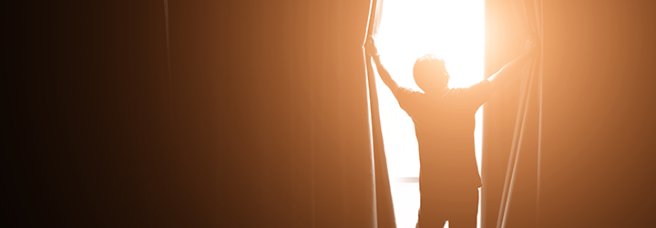 Person opening curtains